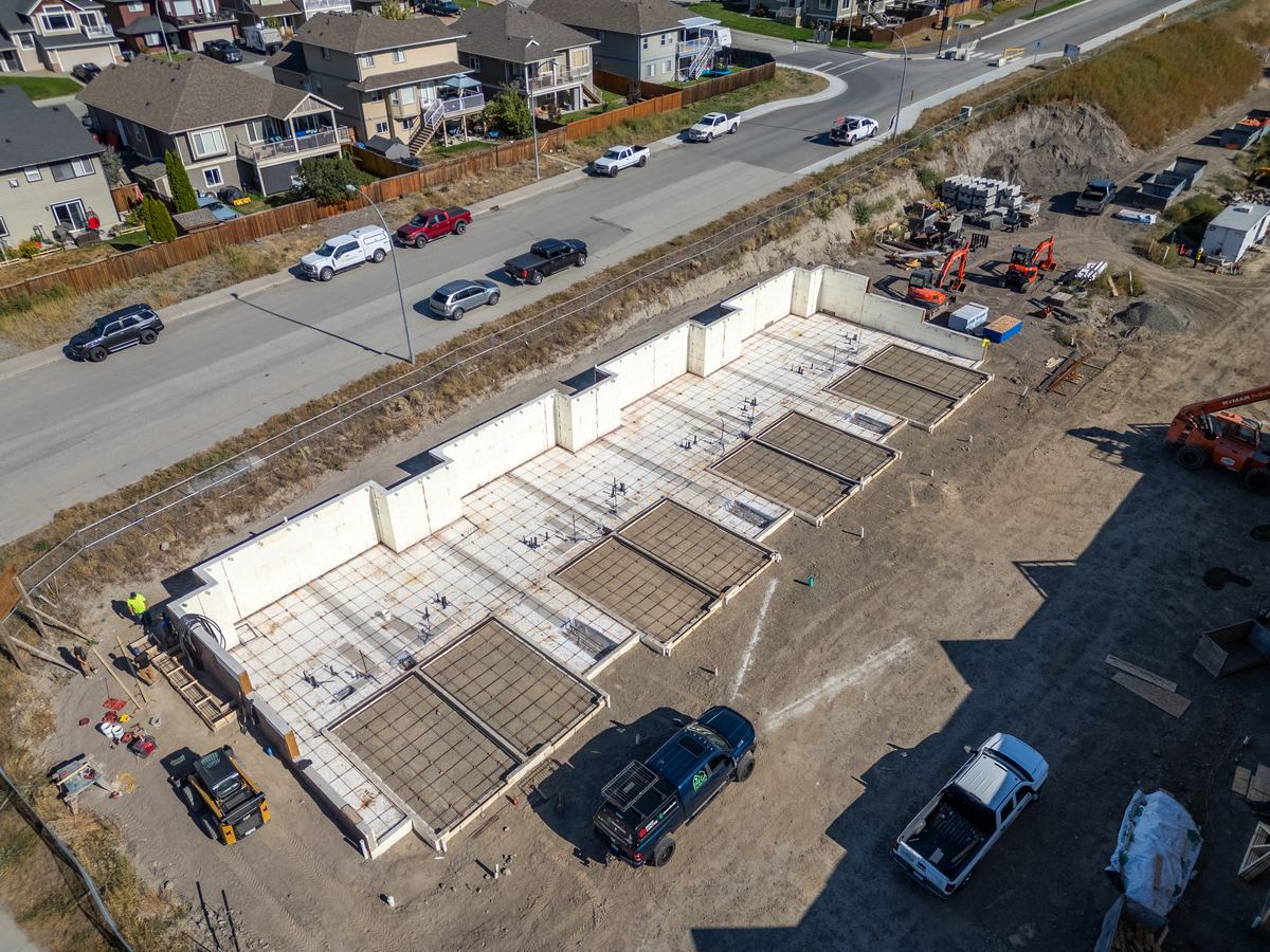 Aerial view of poured foundations for the second building